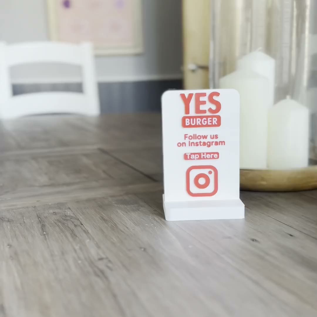 An NFC display on a table beside a phone